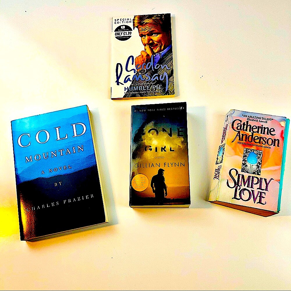 A lot of four new and used paperback books